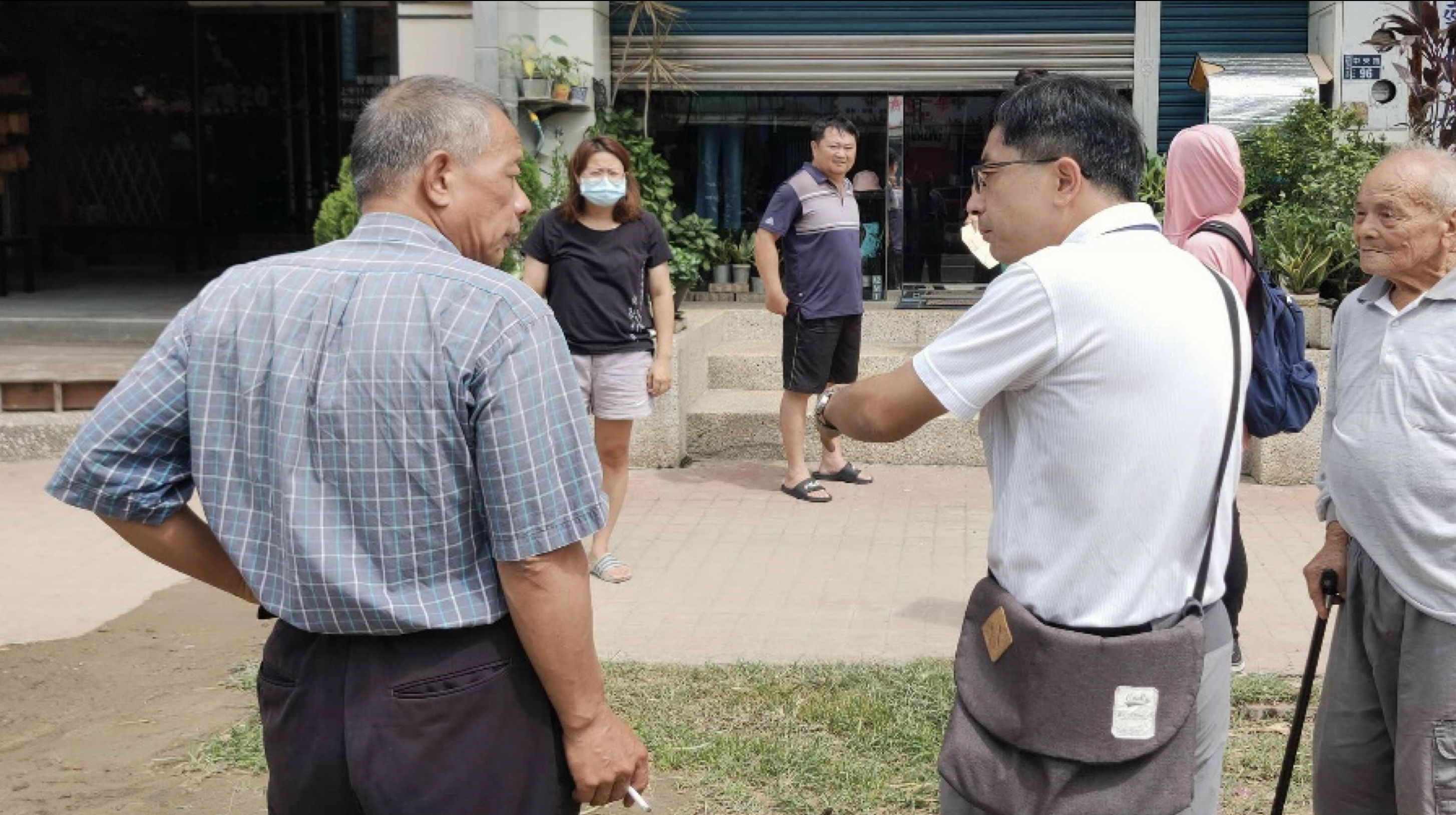 為了向民眾說明汽車不得停放於自家騎樓，苗栗縣政府交通工程科土木科科長黃哲君（圖右2）挨家挨戶拜訪中央路沿線居民耐心溝通。圖片來源：苗栗縣政府。